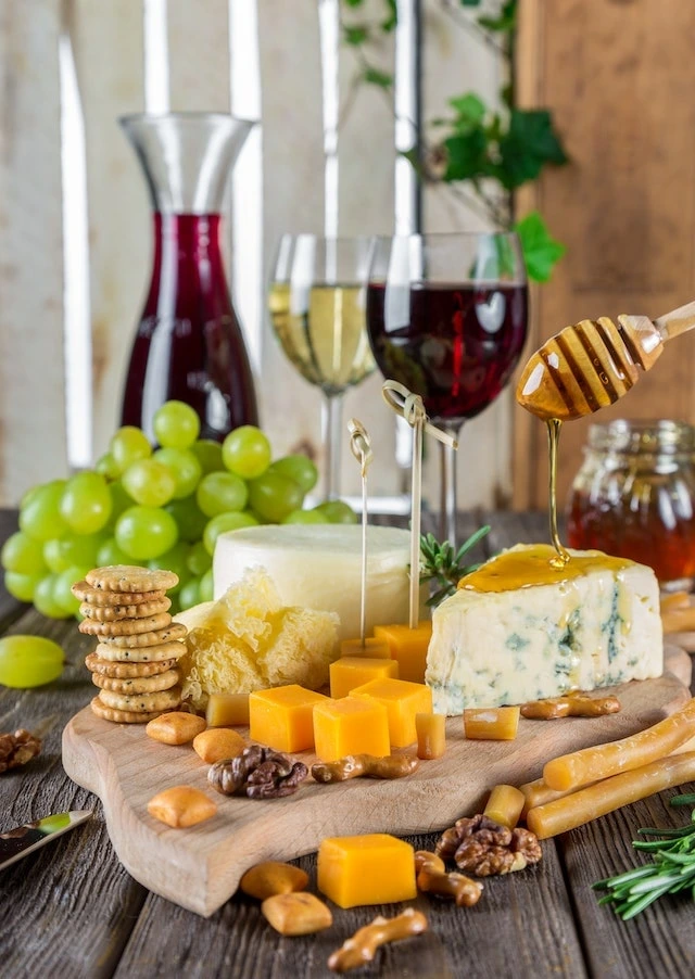 Platter of wine, cheese, crackers and fruit