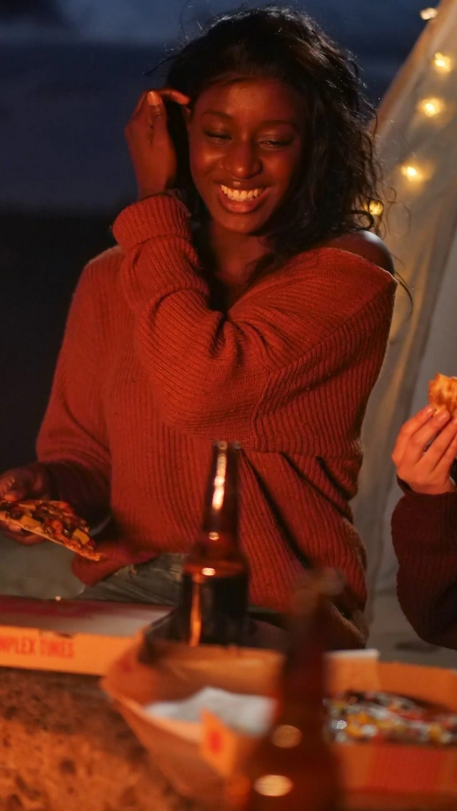 Lady enjoying a slice of pizza