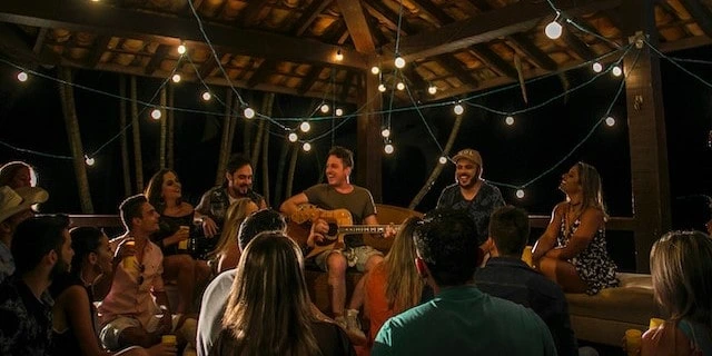 Man playing guitar to a group of people