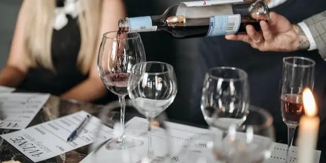 Pouring wine into a glass at a tasting event